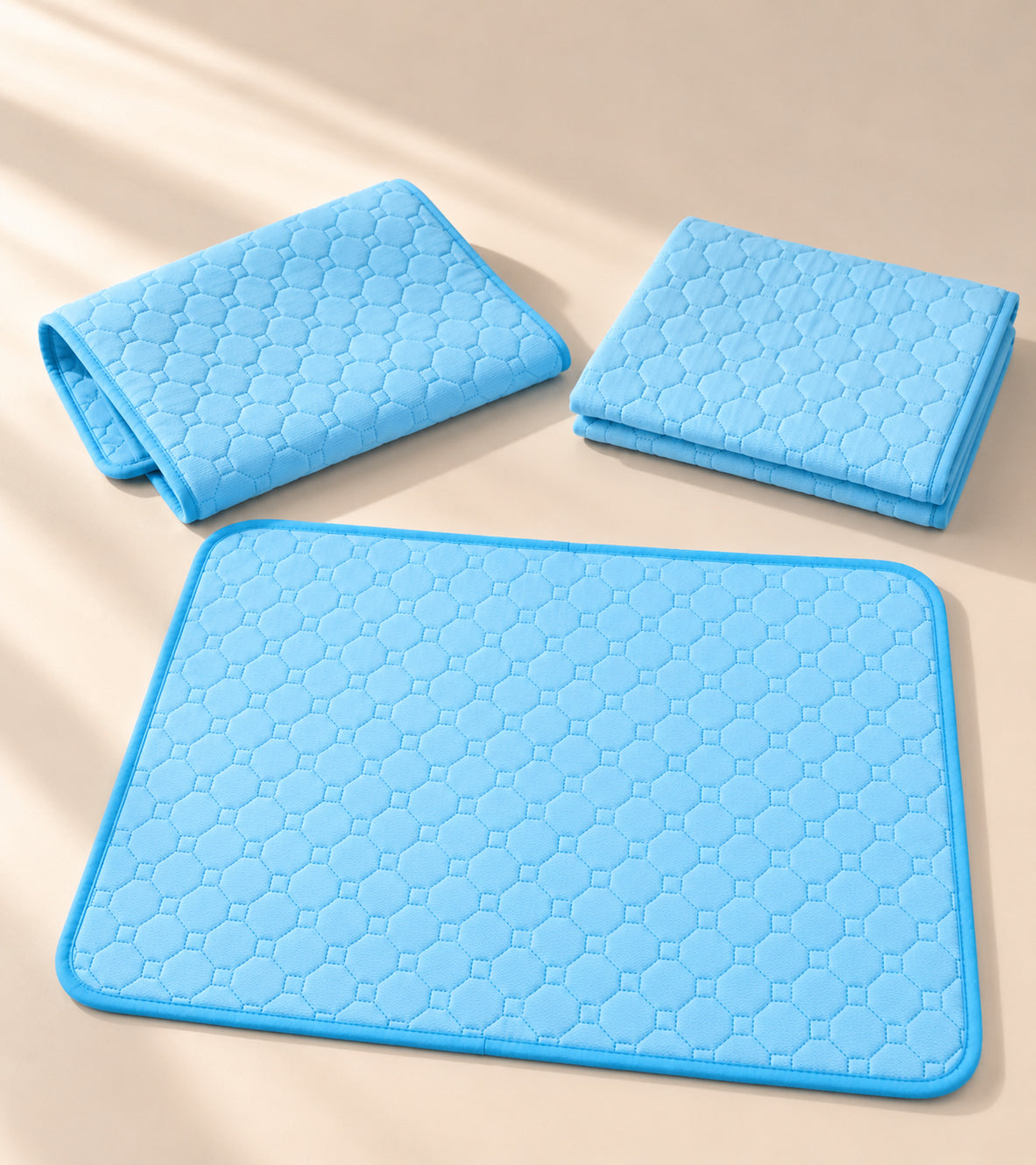 Three blue KoloPads, one unfolded and two folded
